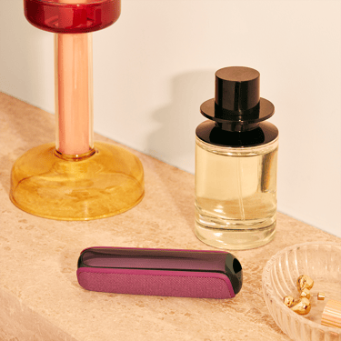 ploom-aura-dark-orchid-device-standing-table
