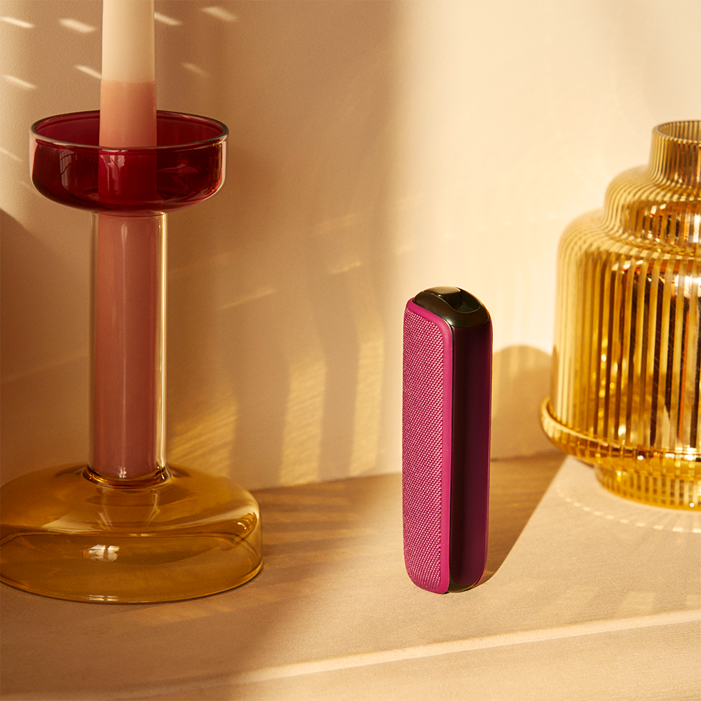 user-pulling-ploom-aura-dark-orchid-device-out-of-drawer